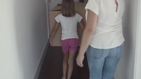 family couple and two girls leaving apartment