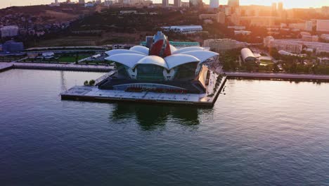 Flying-around-futuristic-architecture-of-Baku-at-sunset,-Azerbaijan