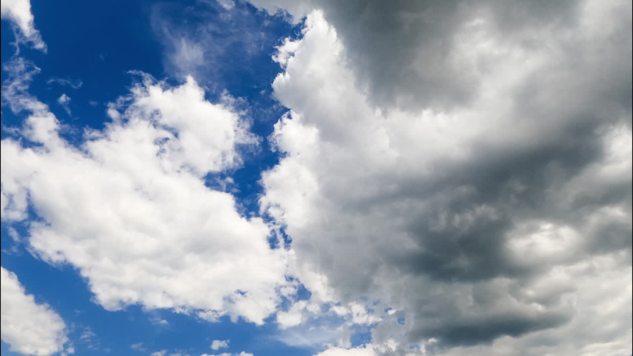 Clouds change their shapes spreading by the atmosphere. Light soft clouds gather in big grey cloudscape. Timelapse.