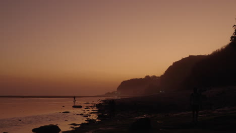 Man-rowing-boat-canoe-sunset-Bali-Gunung-Payung-Beach-Indonesia