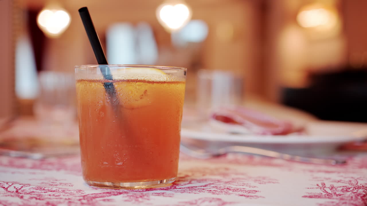 Close up of an orange cocktail on a table at a restaurant