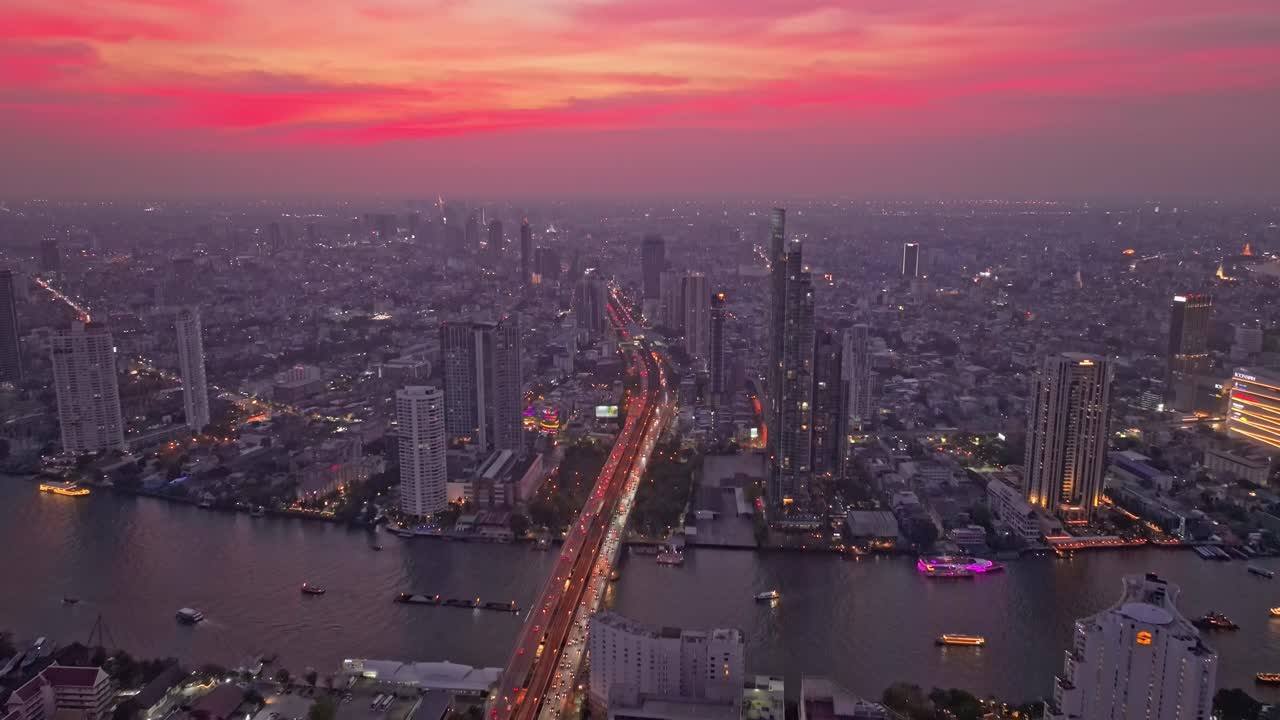 Bangkok economic zone glowing at sunset by Chao Phraya river ,thailand