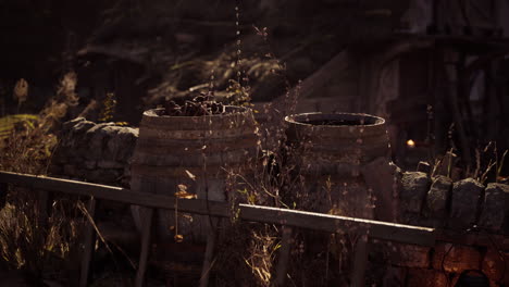 old barrels by a stone wall