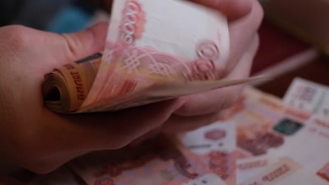 close-up, a man's hand counts 5000 rubles of russian money