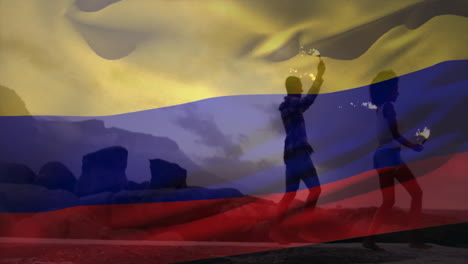 juggling fire, person in silhouette over colombian flag with rocky landscape