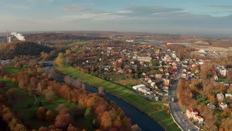 aerial drone shot of a czech big city ostrava with alongside river buldings, cars, roads, apartments during autumn fall day