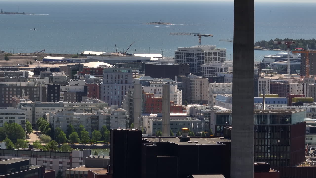 Aerial tracking shot of the cityscape of Ruoholahti and Jatkasaari, in Helsinki