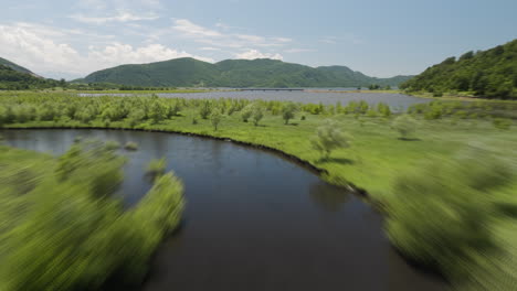 River-tributary-watercourse-in-Tkibuli-reservoir-valley,-fast-flyover