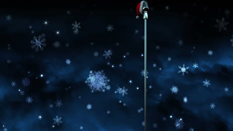 animation of snow falling over microphone with christmas hat on dark background