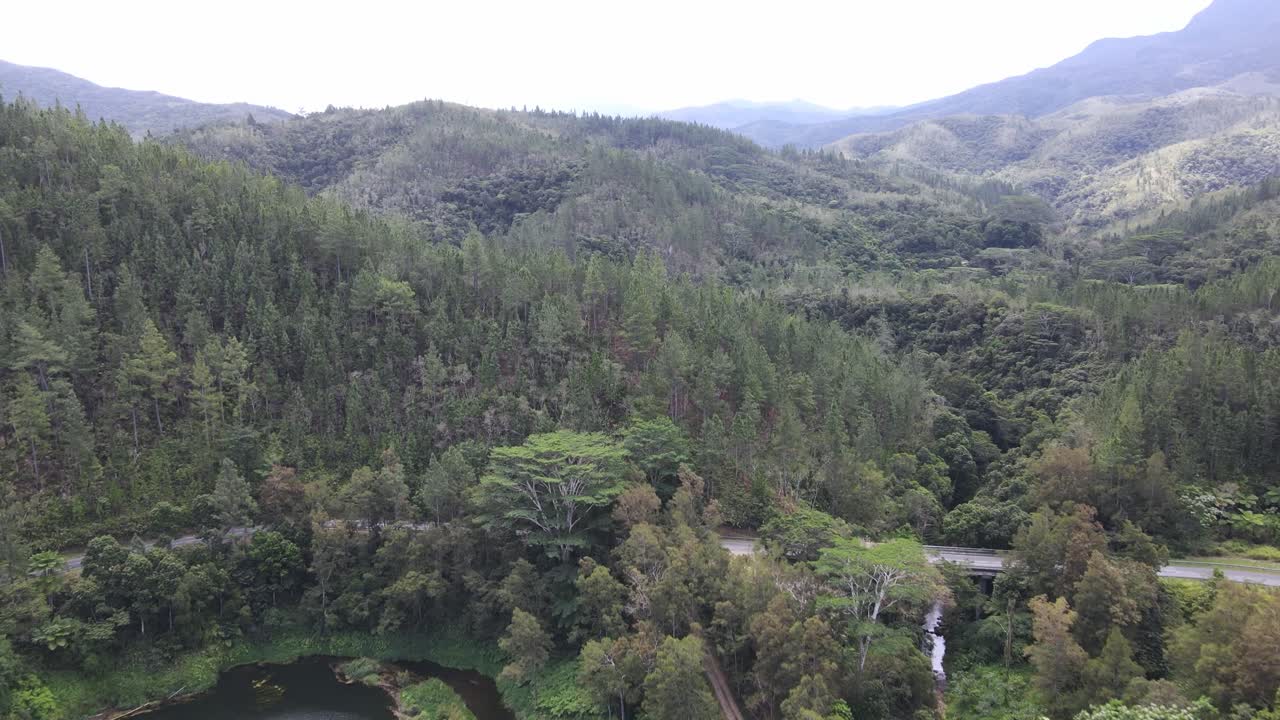 Drone aerial moving forward over a mountain landscape in New Caledonia