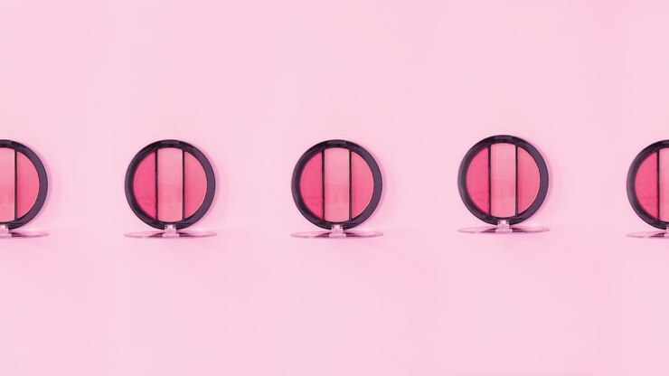 Eye shadow palettes with pink shades rotate on pink background. Stop motion
