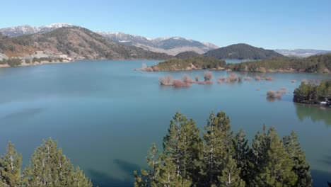 Panoramic-aerial-view-Aoos-spring-lake-Metsovo-Greece-suuny-winter-day