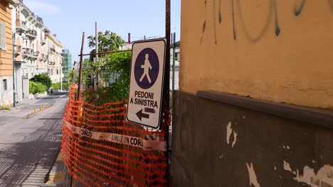 pedestrian sign and construction barriers on street