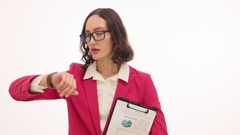 a professional business woman checking her watch while holding a clipboard