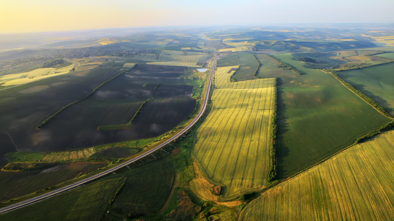 Aerial drone view of nature in Moldova with hills and fields. Sunrise, golden hour