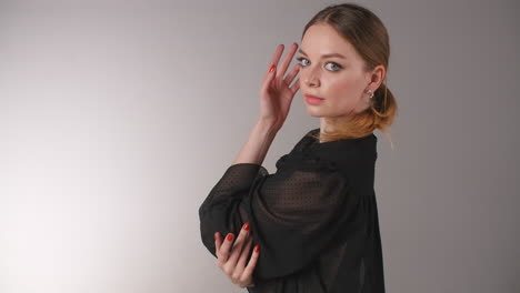 woman in black sheer blouse posing