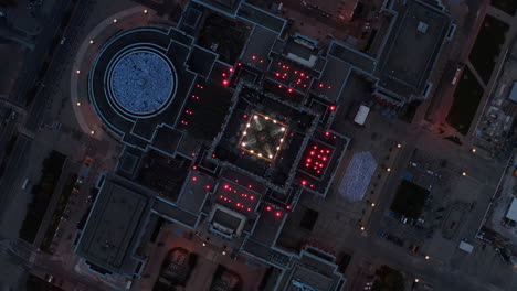 Aerial-birds-eye-overhead-top-down-view-of-Palace-of-Culture-and-Science.-Amazing-shot-of-colour-illuminated-building.-Warsaw,-Poland