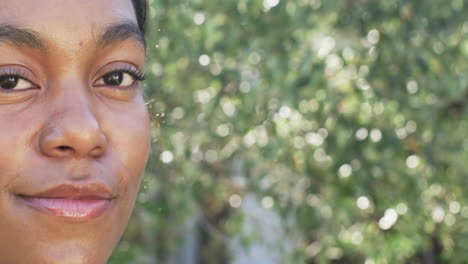 a young african american woman gazes forward, half her face visible, with copy space