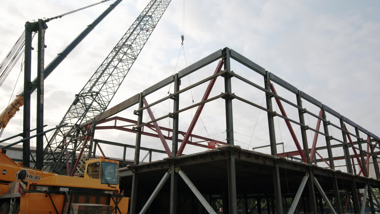 Steel frame building structure under construction with a large crane