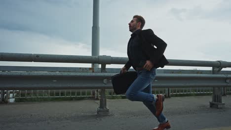 businessman running late on a bridge