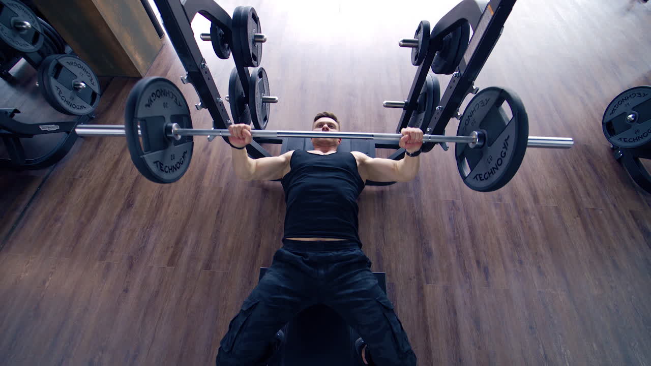 Man doing deadlift exercise at gym. Young man concentrated working at his perfect body