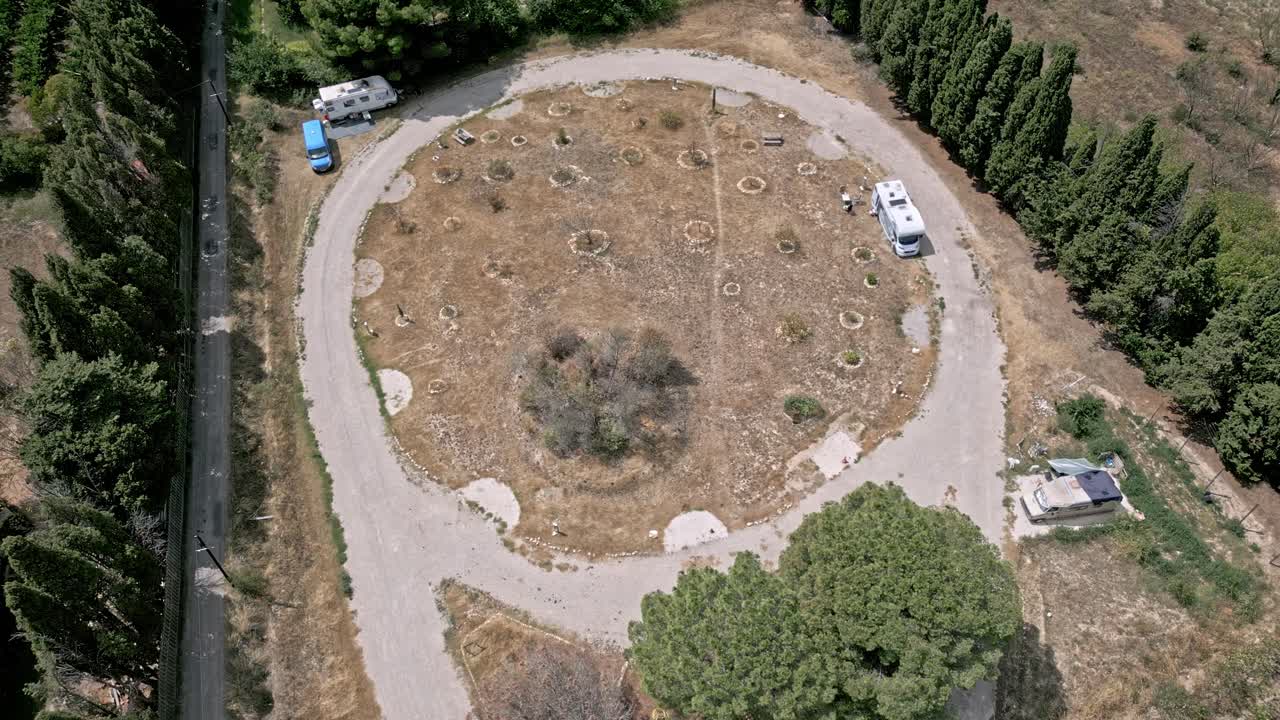 Aerial circling camping car park on sunny day, Ortaffa, France. High angle