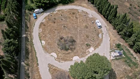aerial circling camping car park on sunny day, ortaffa, france. high angle