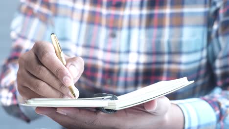 person writing in a notebook