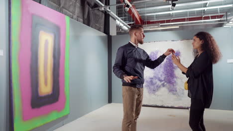 couple discussing abstract art at an exhibition