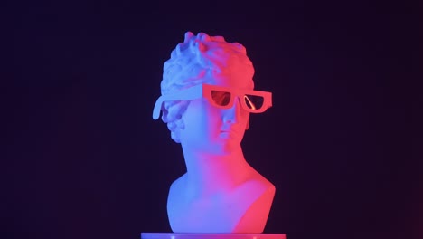 ancient bust with modern glasses in neon lighting