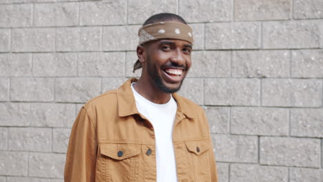 smiling man wearing bandana and jacket