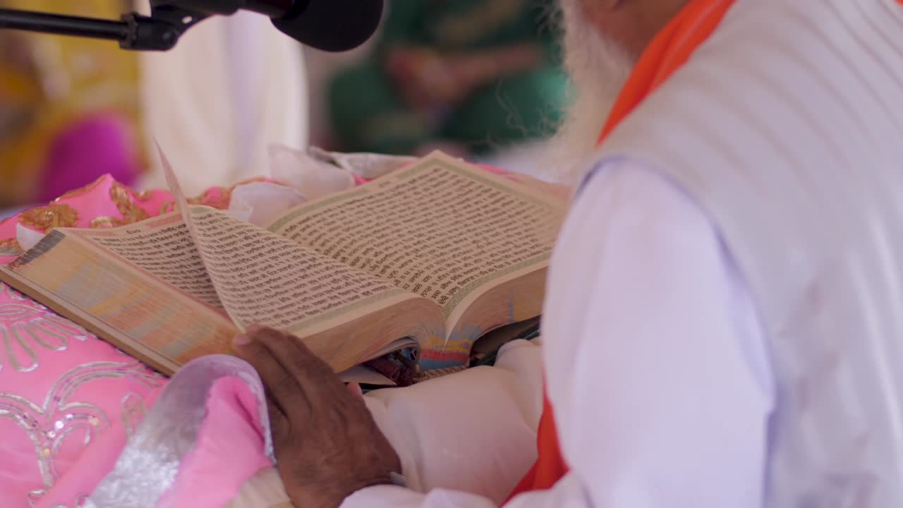 A priest reads from a holy book at a wedding