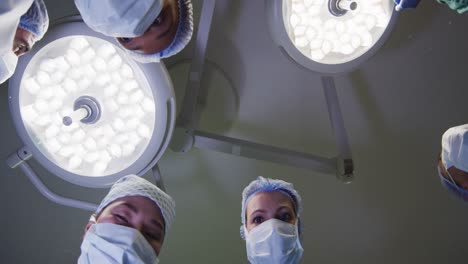 video of patient view looking up at diverse group of surgeons and lights in operating theatre