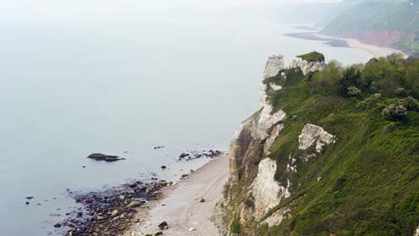 chalk cliffs and rocky pebble beach of branscombe on a very hazy day