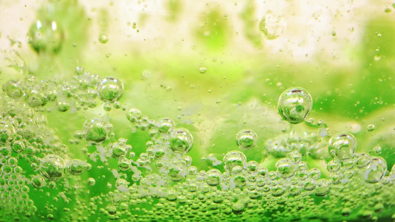 유리 뒤에 잉크가 있는 기름과 물에 있는 거품