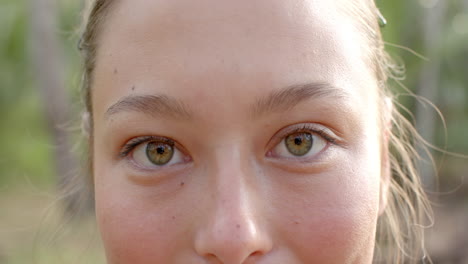 close-up of a young caucasian woman with hazel eyes and a subtle smile