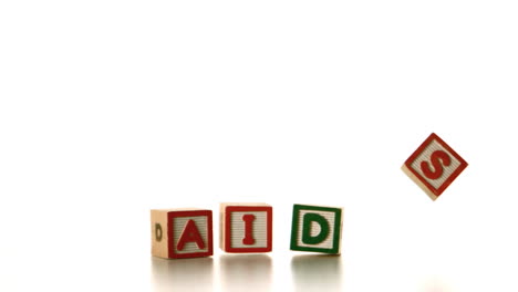 aids spelled out in blocks falling over