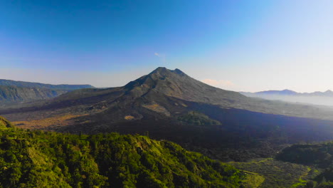 Amazing-aerial-footage-of-an-active-vulcano-in-Asia,-Mount-Batur,-shot-on-a-sunny-day-during-a-holiday