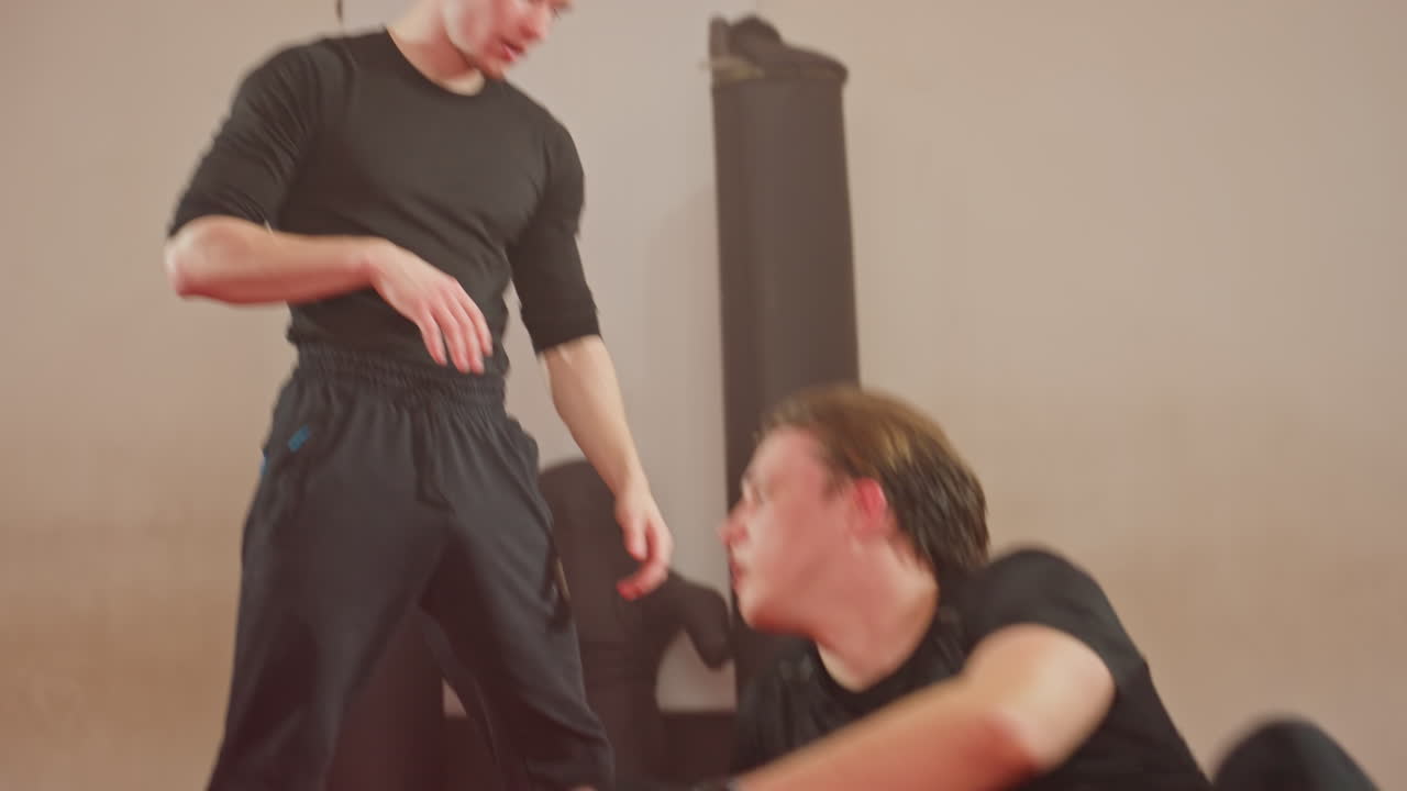 Wrestlers engage in intense sparring session, blocking and countering moves he raised his opponent to the ground, demonstrating technique, agility, and determination during close combat training
