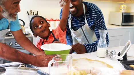 Boy-playing-with-the-flour-while-preparing-cookies