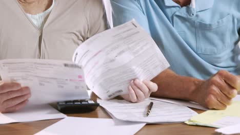 senior couple counting bills