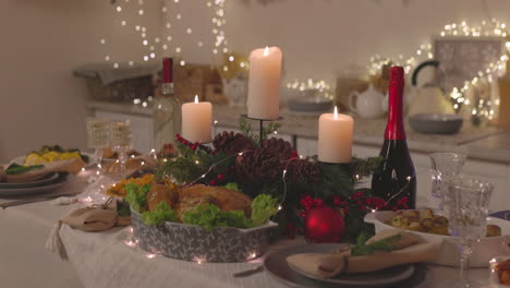 traditional delicious food and burning candles on christmas dinner table