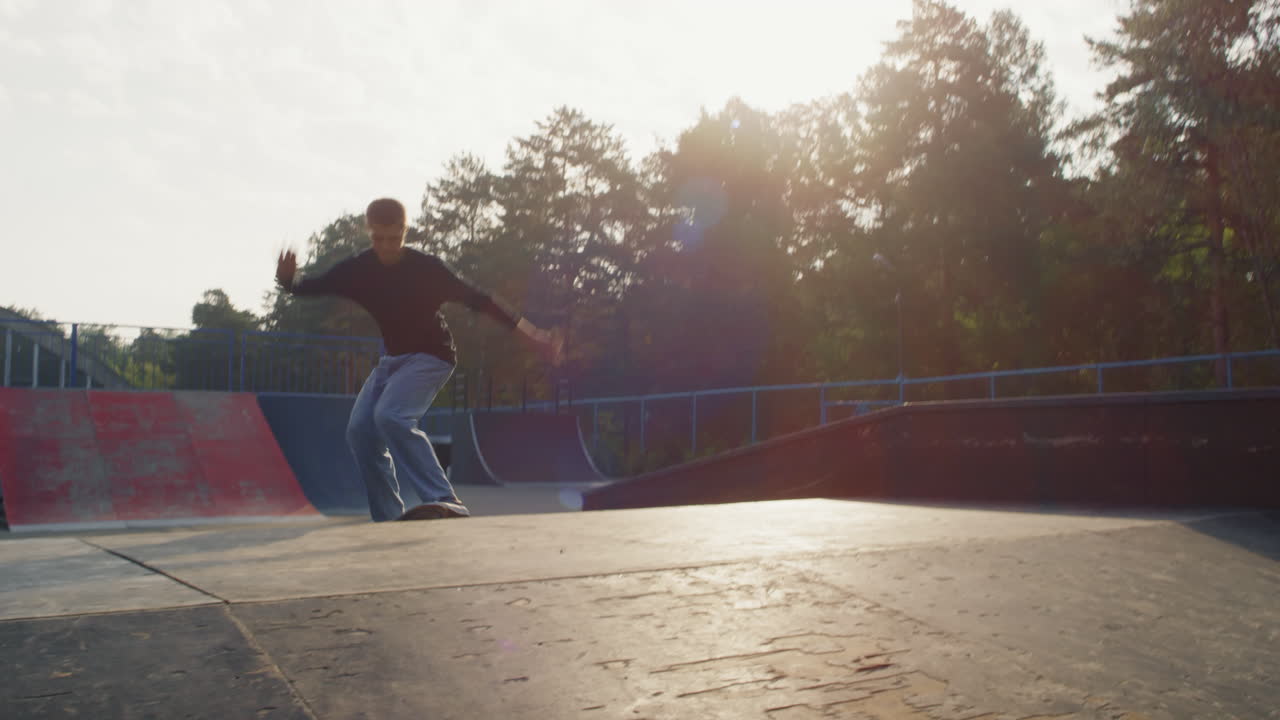 Teen Skating on Ramp and Doing Kickflip