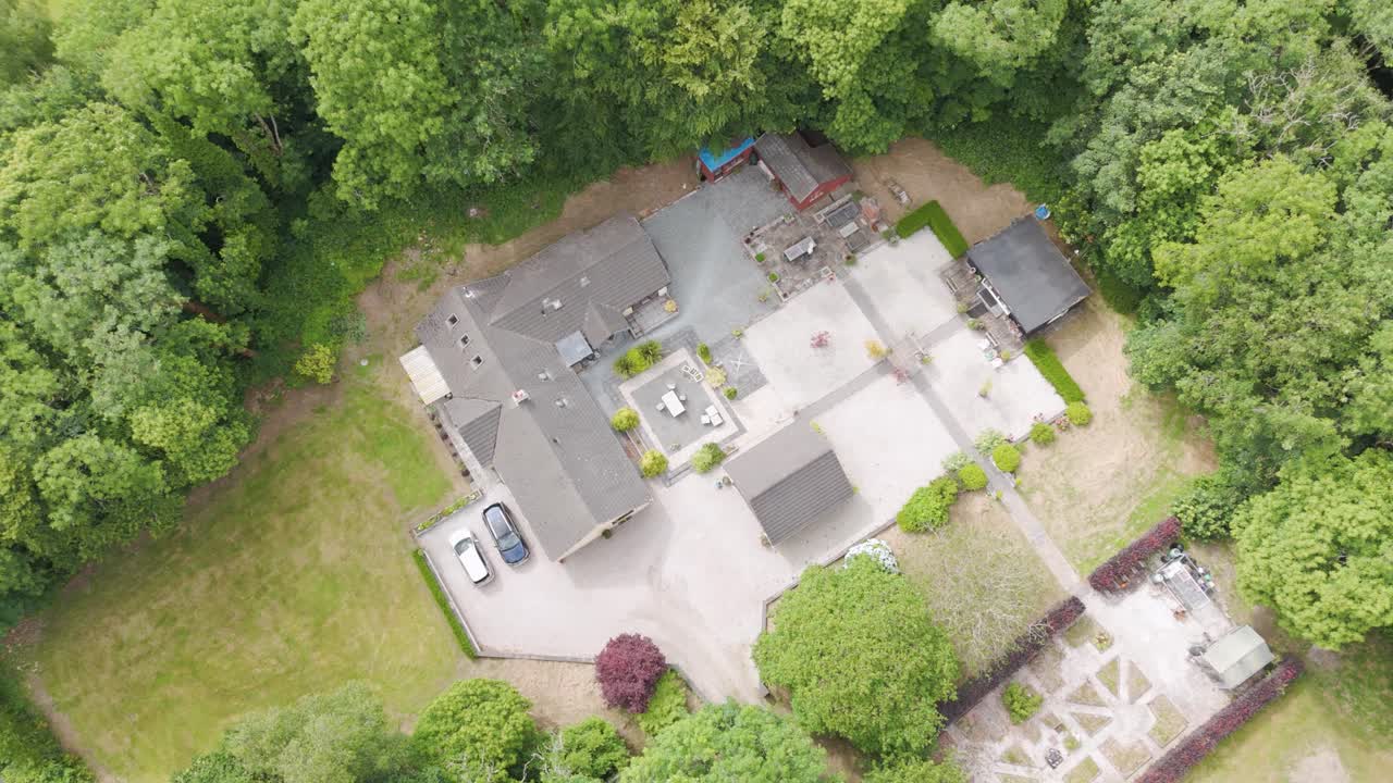 Aerial View of a Large Residential Property with Extensive Gardens and Driveway
