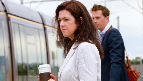 commuters waiting for train at railway station 4k