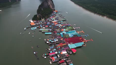 Drone-shot-over-the-Ko-Panyi,-revealing-limestone-cliffs,-in-Phang-Nga-Bay-Thailand