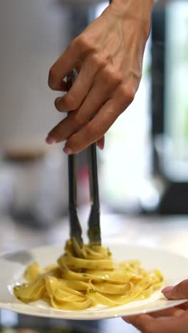 woman serving fettuccine