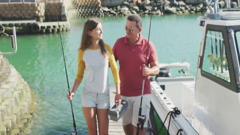 front view of a caucasian man and his teenage daughter go fishing