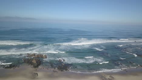 Relaxing-aerial-view-drone-birdeye-waves-breaking-on-coastal-landscape,-atlantic-ocean-waves-on-beach-shore,-beautiful-wild-nature-shot