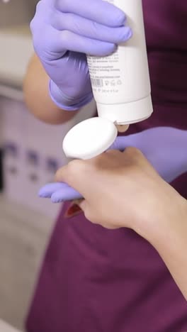 applying cream to a hand in a spa